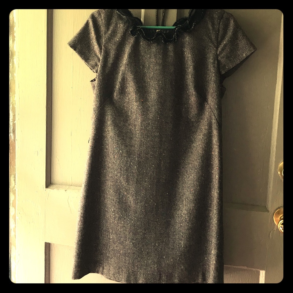 Adorable mini dress with ruffle adornments.